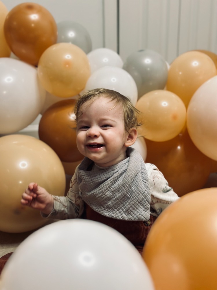 Baby Smiling Amongst Balloons